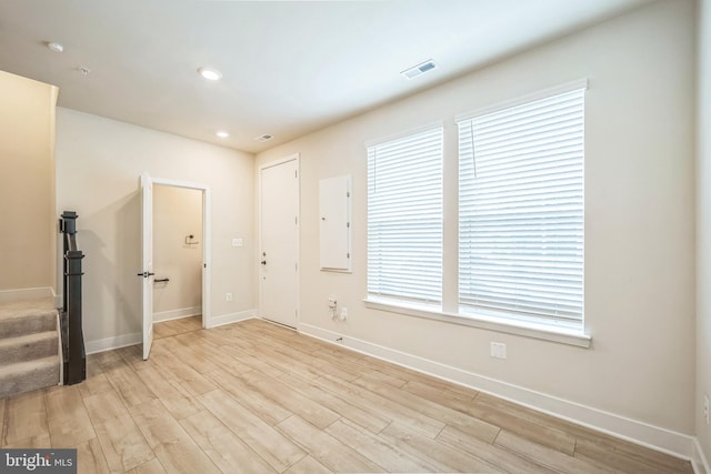 empty room with a healthy amount of sunlight and light hardwood / wood-style floors