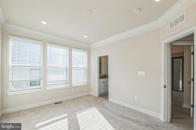 unfurnished bedroom with ornamental molding, connected bathroom, and multiple windows