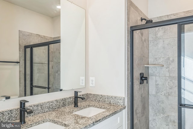 bathroom with vanity and a shower with door