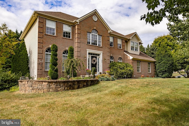 colonial home with a front lawn