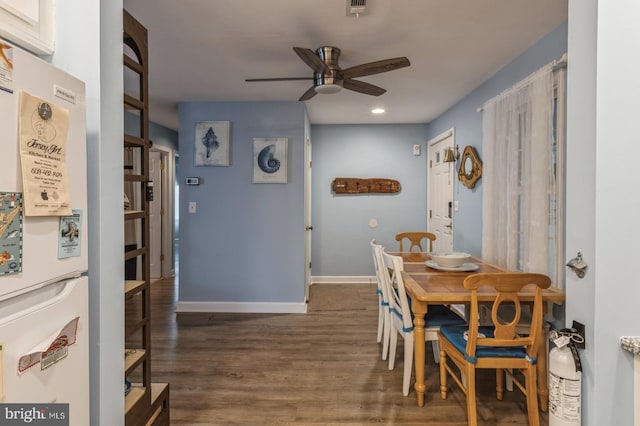 dining space featuring ceiling fan and dark hardwood / wood-style flooring