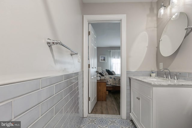 bathroom featuring vanity, tile patterned flooring, and tile walls