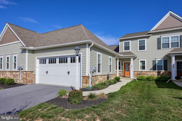 view of front facade with a garage and a front lawn