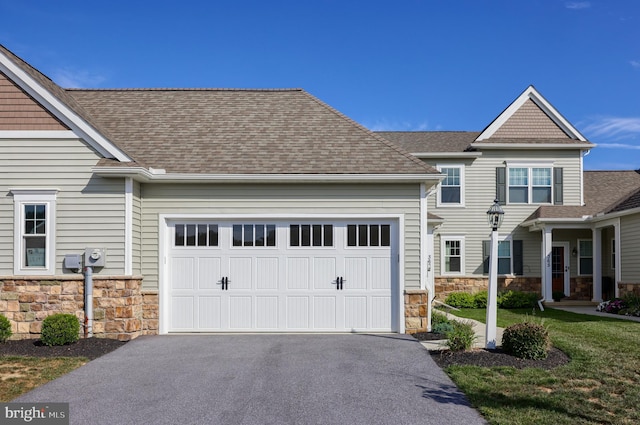 view of front of property with a front lawn and a garage