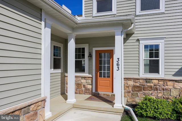 view of exterior entry with covered porch