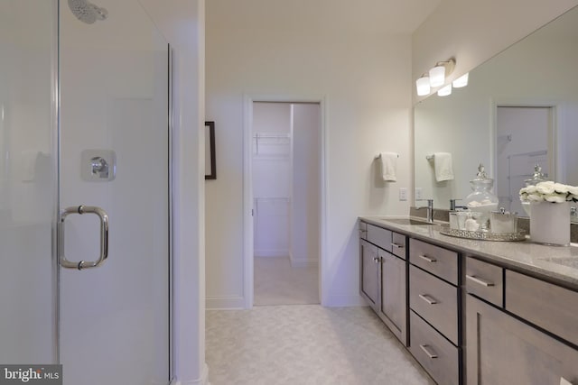 bathroom with walk in shower and vanity