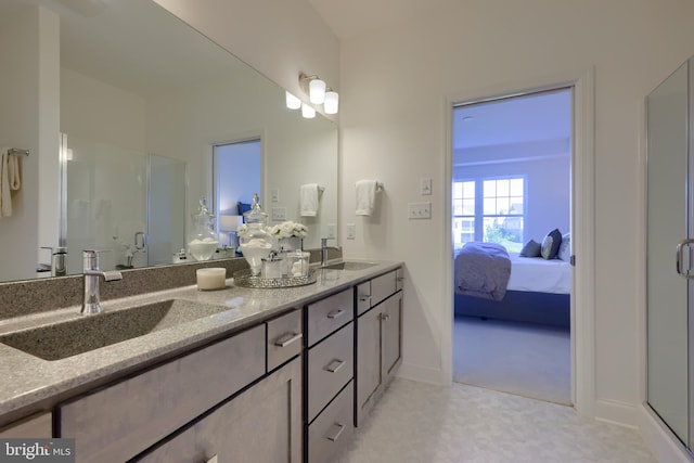 bathroom with vanity and a shower with shower door