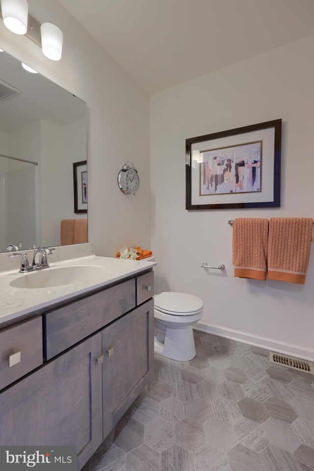 bathroom featuring vanity and toilet