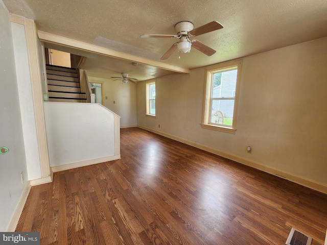 unfurnished living room with a textured ceiling, wood-type flooring, and ceiling fan