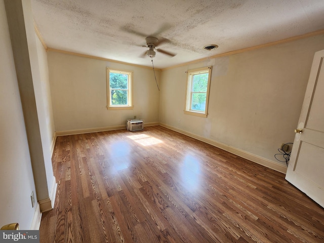 spare room featuring ceiling fan, a textured ceiling, crown molding, and hardwood / wood-style floors