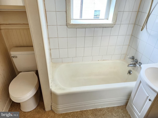 bathroom featuring toilet, vanity, and a washtub