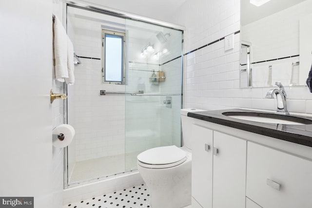 bathroom with walk in shower, tile patterned flooring, vanity, and toilet