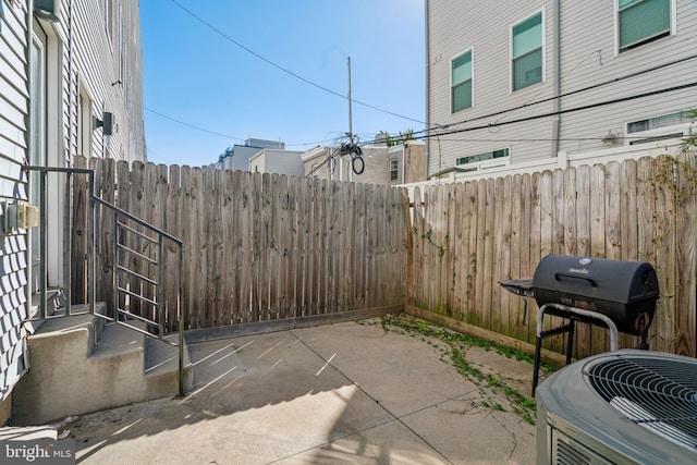 view of patio / terrace with central air condition unit and area for grilling