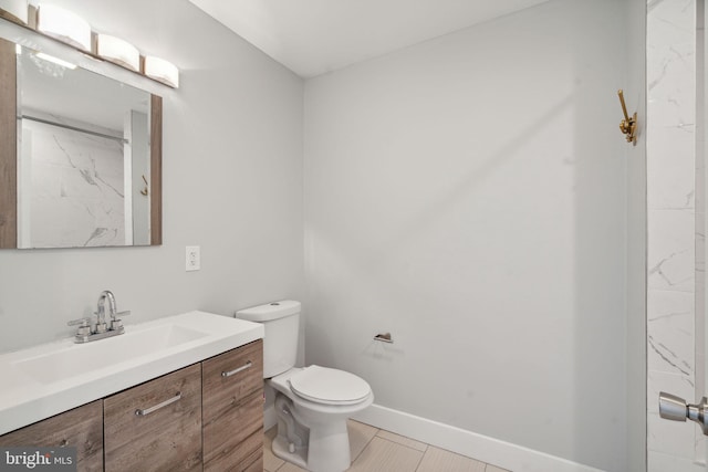 bathroom featuring tile patterned flooring, vanity, and toilet