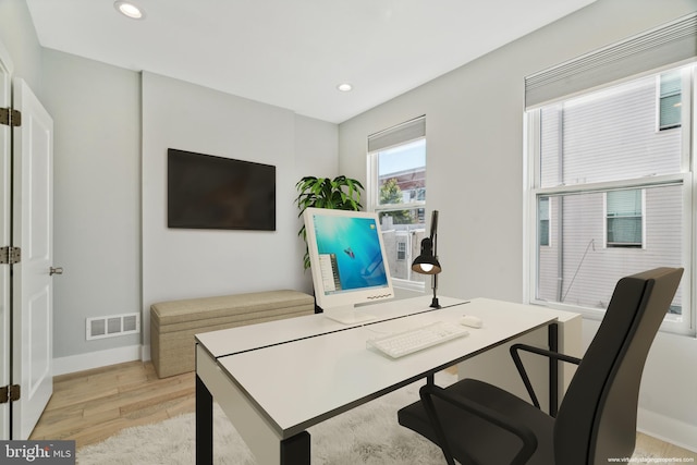 office area with light hardwood / wood-style floors