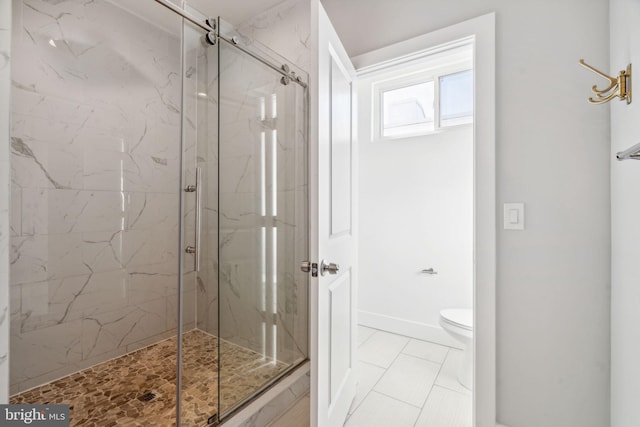 bathroom featuring tile patterned flooring, walk in shower, and toilet