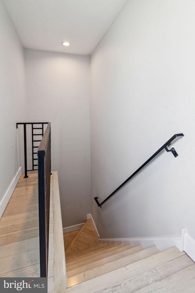 staircase featuring wood-type flooring