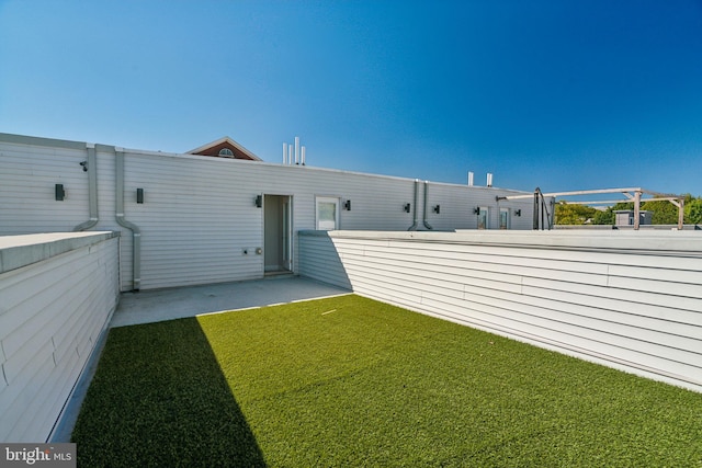 rear view of property featuring a patio area and a lawn