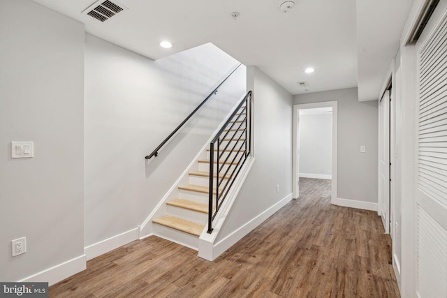 stairway featuring hardwood / wood-style floors