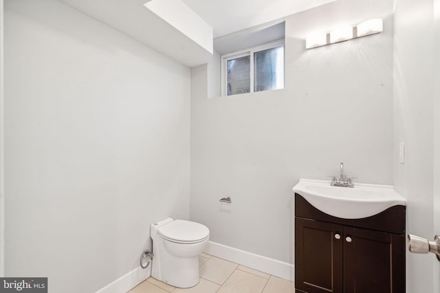 bathroom with vanity, tile patterned flooring, and toilet