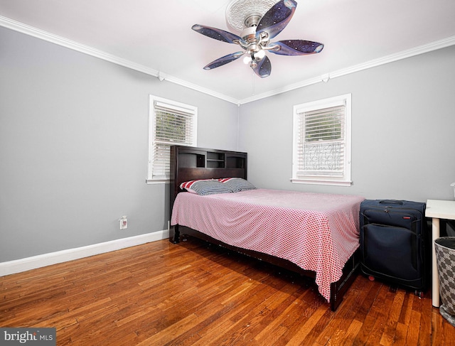 bedroom with hardwood / wood-style flooring, multiple windows, and ceiling fan