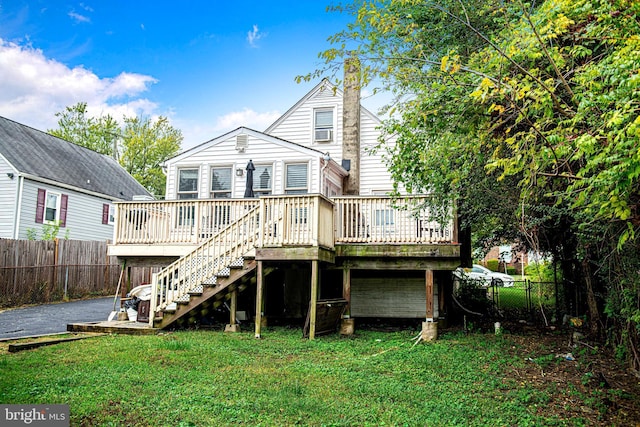 back of house with a yard and a deck