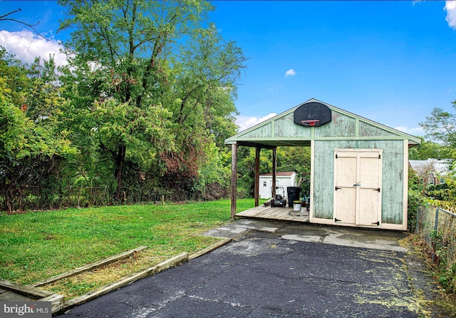 view of outbuilding with a yard