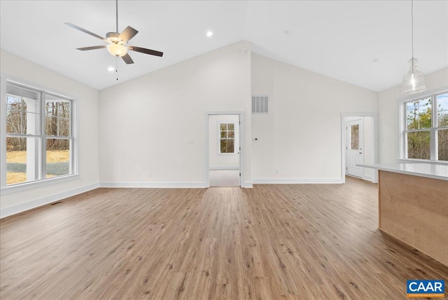 unfurnished living room featuring ceiling fan, high vaulted ceiling, and light hardwood / wood-style floors