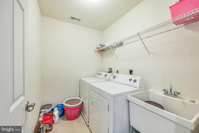 laundry room with washing machine and dryer and sink