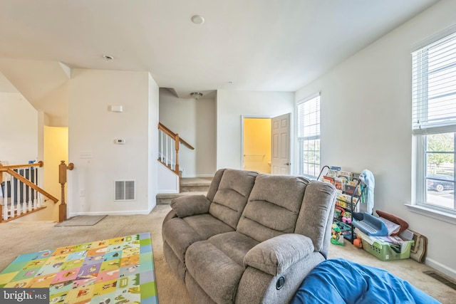 living room featuring light carpet and a wealth of natural light