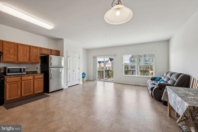 kitchen featuring appliances with stainless steel finishes and decorative light fixtures