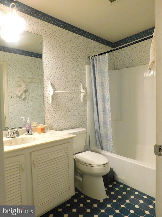 full bathroom featuring shower / bath combination with curtain, vanity, and toilet