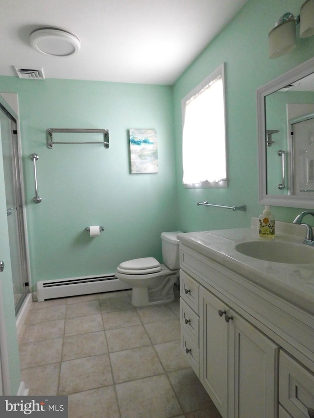 bathroom with toilet, tile patterned floors, a shower with door, a baseboard heating unit, and vanity