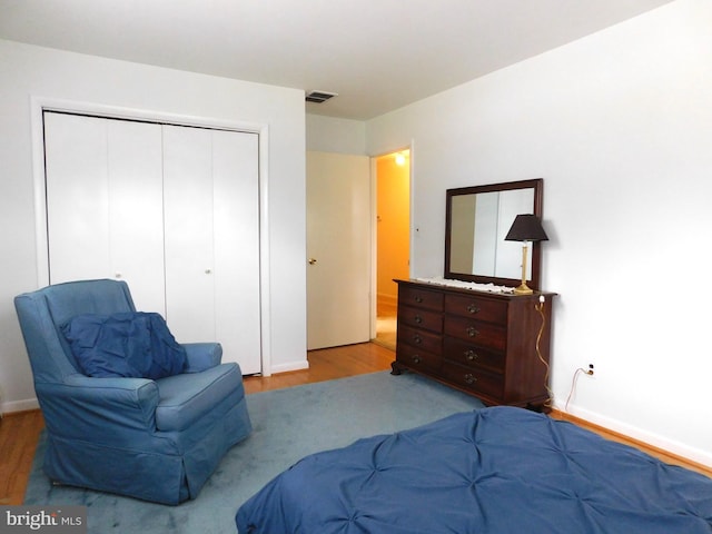 bedroom featuring a closet and light wood-type flooring