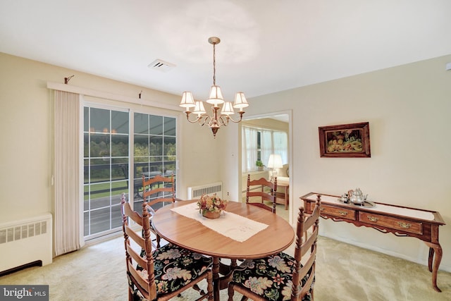 dining area with radiator heating unit, light carpet, and a chandelier