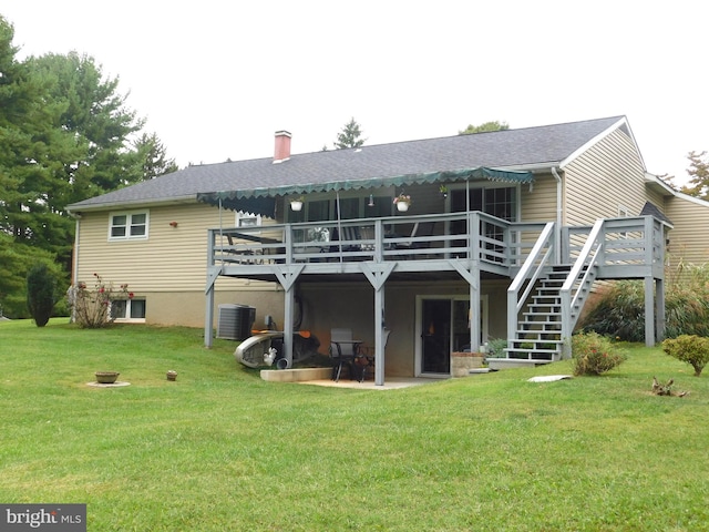 back of property featuring a deck, a yard, and a patio area