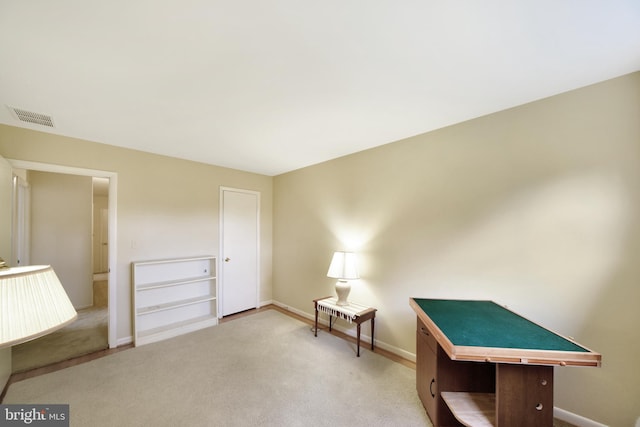 sitting room featuring carpet floors and baseboards