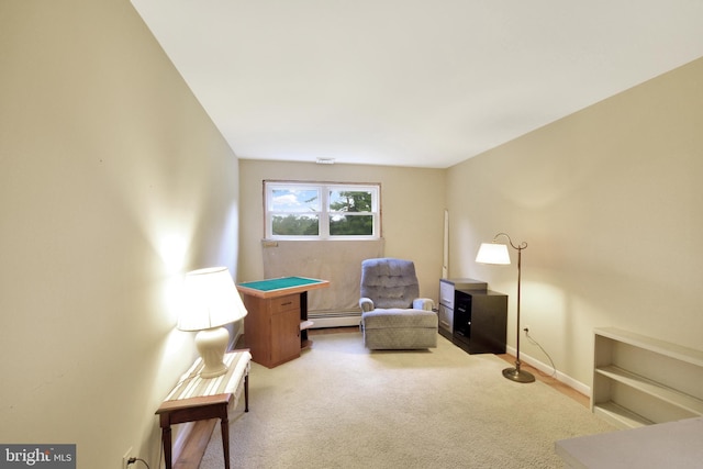 sitting room featuring carpet floors, a baseboard heating unit, and baseboards