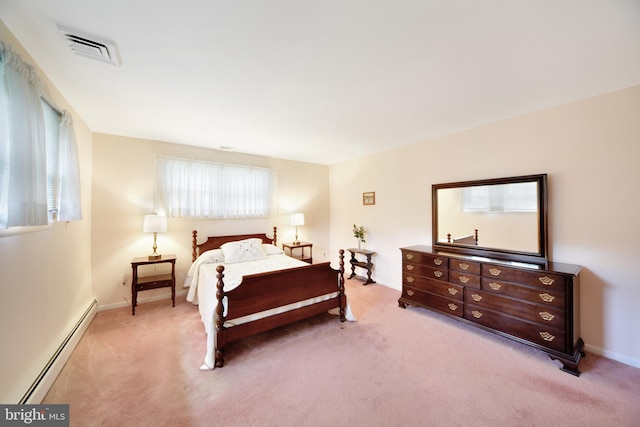 bedroom with baseboard heating, light colored carpet, and baseboards