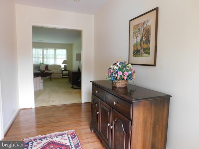 hallway with light hardwood / wood-style flooring