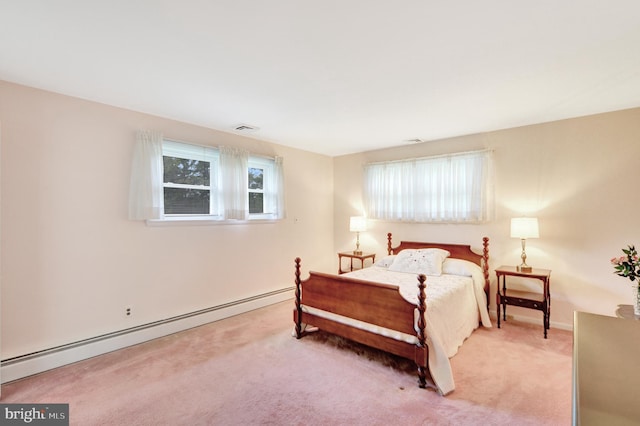 carpeted bedroom featuring baseboard heating