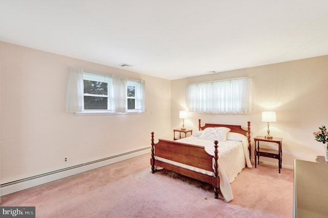 bedroom featuring a baseboard heating unit, carpet, and baseboards