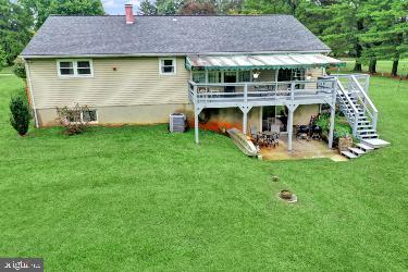 back of house featuring a yard