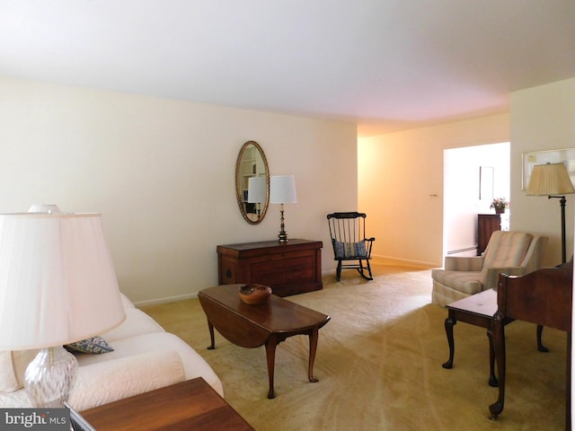 living area featuring baseboard heating and light colored carpet