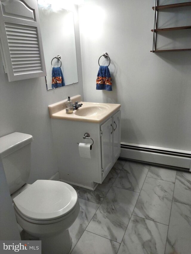 bathroom featuring a baseboard heating unit, marble finish flooring, toilet, and vanity