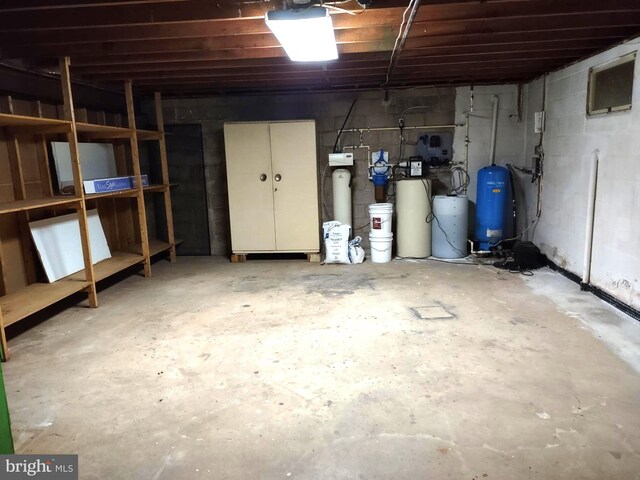 basement featuring a water pressure tank and a water softener system