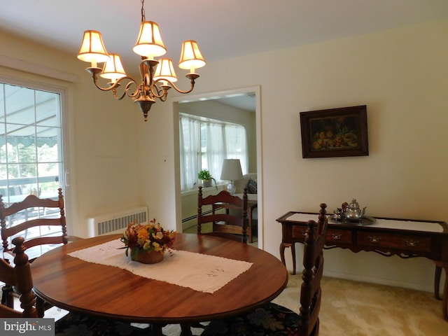 dining room with light carpet, a wealth of natural light, and an inviting chandelier