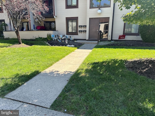 entrance to property featuring a yard