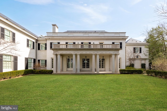 back of house with a yard, a patio, french doors, and a balcony