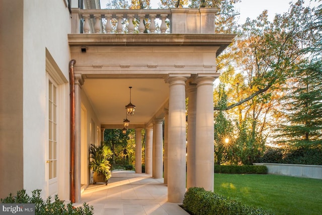 property entrance with a lawn